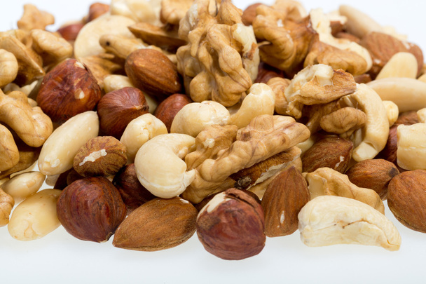gemischte Nüsse - Haselnüsse, Walnüsse, Cashewnüsse, Pinienkerne isoliert auf weißem Hintergrund - Foto, Bild