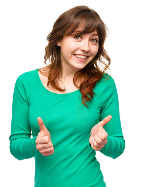 Woman is showing thumb up gesture - Foto, immagini