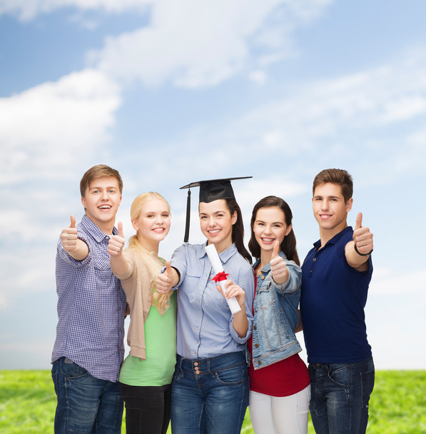 group of students with diploma showing thumbs up - Foto, Bild