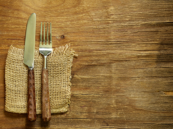 Cutlery (knife and fork) on wooden background - Photo, Image