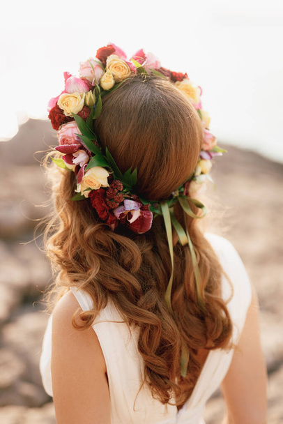 Nevěsta s věncem růží na hlavě, pohled zezadu. Květinový věnec na hlavě dívky pro hnědé vlasy.  - Fotografie, Obrázek