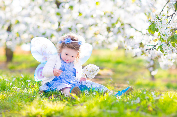 maluch kręcone dziewczyna w stroju wróżki gry ogród owoców - Zdjęcie, obraz