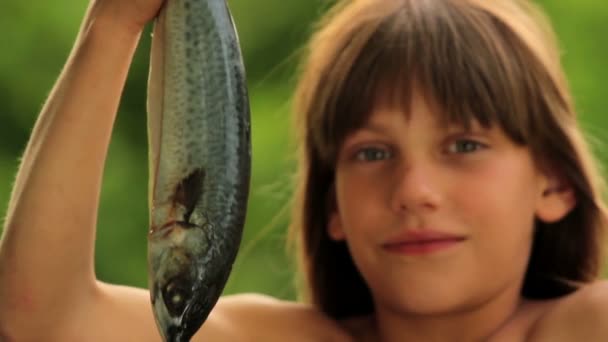 Boy holding a marine fish.Child preparing fish.Little cook. - Felvétel, videó
