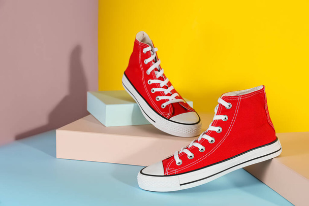 Pair of stylish sneakers on color background - Photo, image