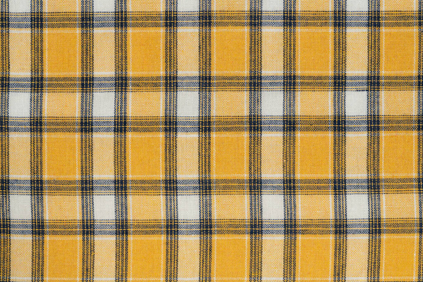Yellow white tartan texture background. shirt fabric with a checkered pattern. factory material - Photo, Image