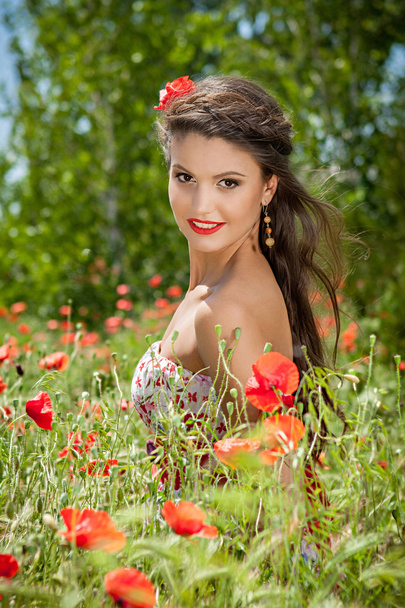 beautiful  happy female in the poppy flower - Zdjęcie, obraz