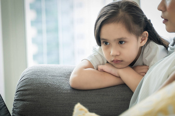 Family lifestyle concept, child showing tantrum or meltdown behavior at the sofa - Фото, изображение