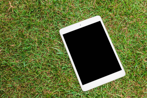 tablet 8.4 inches on green glass background - Φωτογραφία, εικόνα