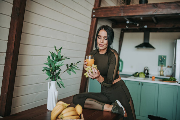 beautiful sporty woman posing on kitchen with healthy food - Photo, Image