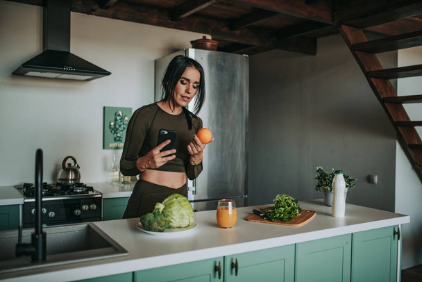 young sporty woman making photos on kitchen - Valokuva, kuva