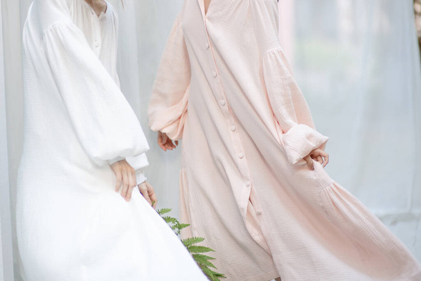  women in dresses posing against cloth - Foto, afbeelding