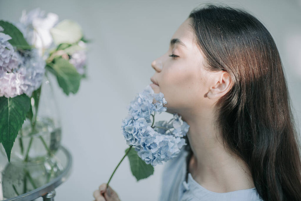 beautiful girl posing with hydrangea flowers  - Photo, Image