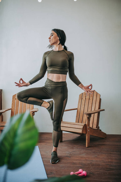 young beautiful woman doing yoga at home  - Фото, изображение