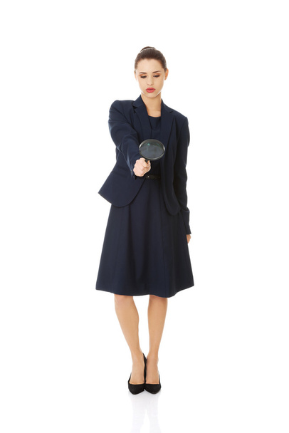 Business woman looking into a magnifying glass - Foto, Imagen
