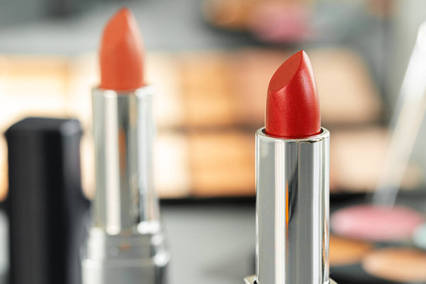 Pink and red lipsticks on vanity table - Foto, Bild