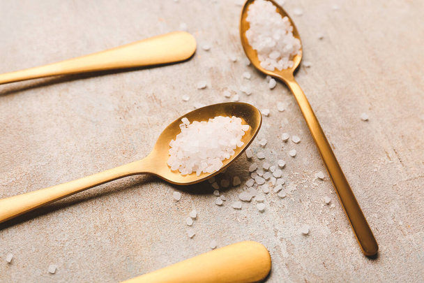 Spoons with salt on grey background - Foto, imagen