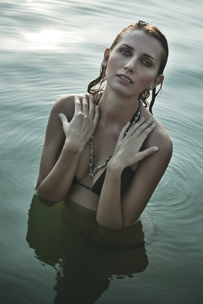 Young woman in river - Фото, изображение