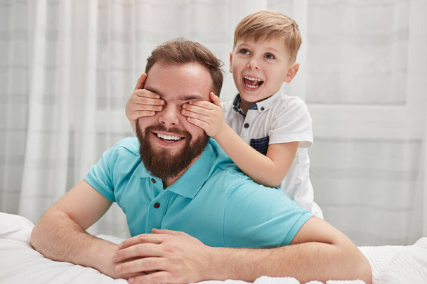 Happy son making surprise to father - Foto, afbeelding