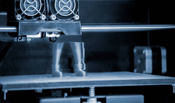 3D printer prints the form of molten plastic green. - Photo, image