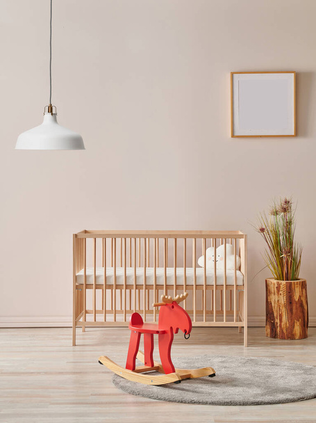 Modern baby room with wooden bed and lamp concept. - Foto, afbeelding