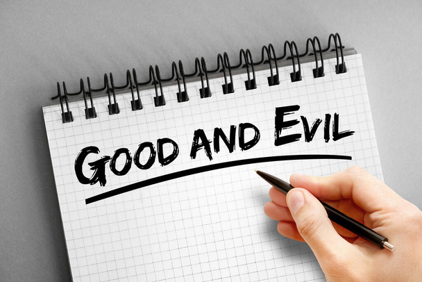Good and evil text on notepad, concept background - Foto, Imagen