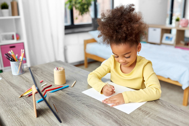 little girl drawing with coloring pencils at home - Foto, immagini