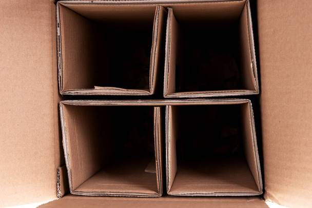 Closeup brown cardboard box with dividers. Glass bottle transport box - Photo, Image