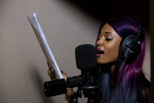 JOHANNES, SOUTH AFRICA - Jan 18, 2021: Johannesburg, South Africa - April 28, 2015: Vanessa Mdee, Tanzania singer recording vocal part on Afro-pop song in studio - Photo, Image