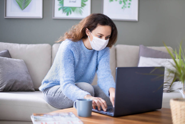 Young business woman working from home wearing protective mask after coronavirus pandemi - Zdjęcie, obraz