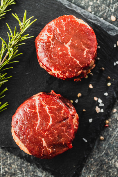 The raw beef meat steak on cutting board. Top view. - Zdjęcie, obraz