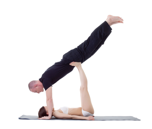 Studio shot of athletic trainers practicing yoga - Фото, изображение