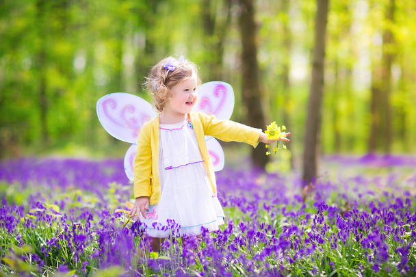 Toddler girl in fairy costume in bluebell forest - Photo, Image