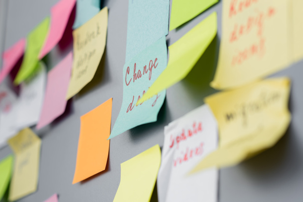 Sticky notes with lettering on board in office  - Foto, Imagen