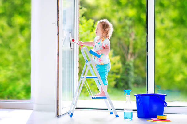 Little girl washing a window - Photo, Image