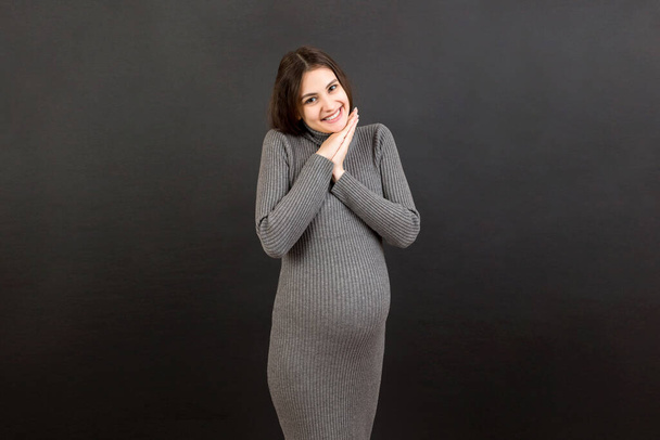 Young beautiful pregnant woman on isolated colored background celebrating surprised and amazed for success with arms raised and open eyes. Winner concept. - Foto, Imagem