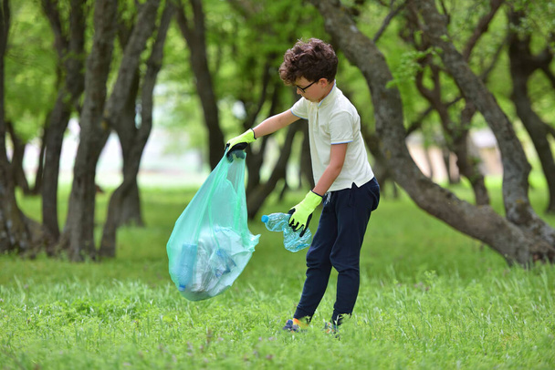 Recycle waste litter rubbish garbage trash junk clean training. Nature cleaning, volunteer ecology green concept. Young men and boys pick up spring forest at sunset. Environment plastic pollution - Zdjęcie, obraz