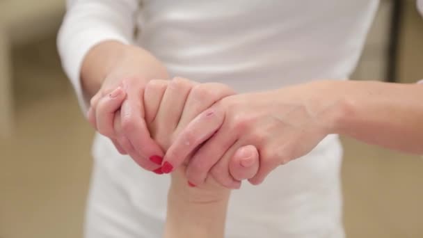Woman beautician doing hand massage to client. - Záběry, video