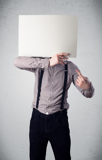 Businessman holding in front of his head a paper with copy space - Foto, Imagem