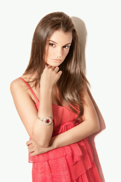 beautiful brunette woman model posing in red dress in the studio - Photo, image