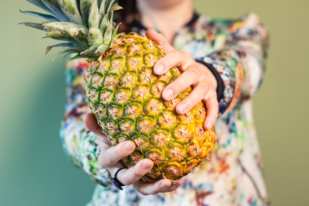 Dziewczyna mody gospodarstwa ananas między jej ręce - Zdjęcie, obraz