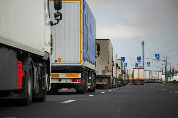 długi korek drogowy wielu ciężarówek na granicy, długie oczekiwanie na kontrole celne między państwami z powodu epidemii koronawirusów, zwiększona kontrola sanitarna transportu towarowego - Zdjęcie, obraz
