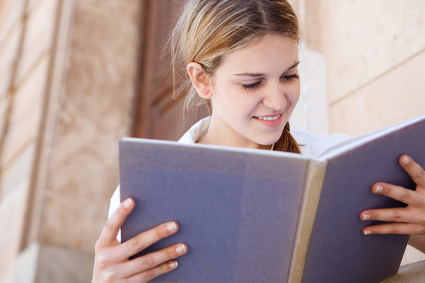 Girl reading her notebook - Φωτογραφία, εικόνα