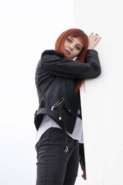 Red-haired young girl in a white shirt and leather jacket - Фото, зображення