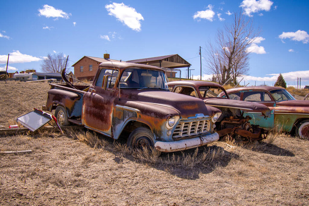 An old rusty truck against beautiful sky in the junkyard - Foto, Imagem