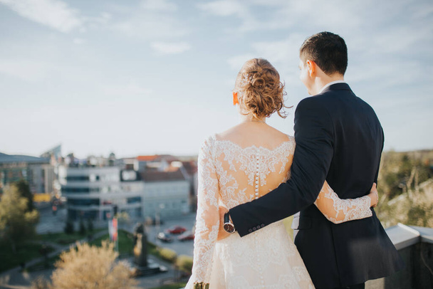 A closeup shot of Caucasian wedding couple looking to the city in Bosnia and Herzegovina - Фото, изображение