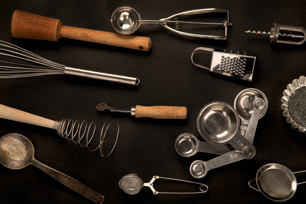 Set of kitchen utensils on black background. Tools for cooking. Top view - Fotoğraf, Görsel