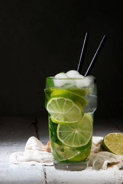 Fresh made Mojito cocktail on dark background. Summer drinks concept. Front view, Copy space - Φωτογραφία, εικόνα