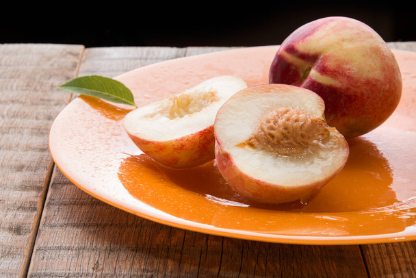 Peaches on a wooden background.  - Zdjęcie, obraz