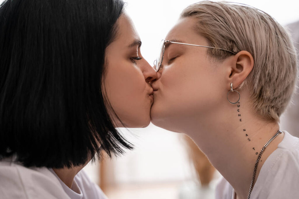 side view of loving lesbian couple kissing at home - Fotoğraf, Görsel