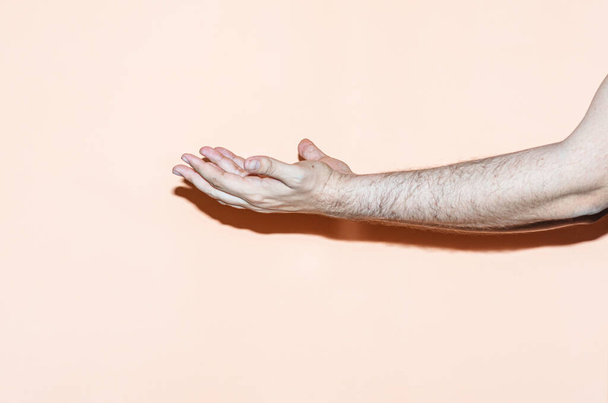 Hand gesture on orange background. Pray gesture - Photo, Image